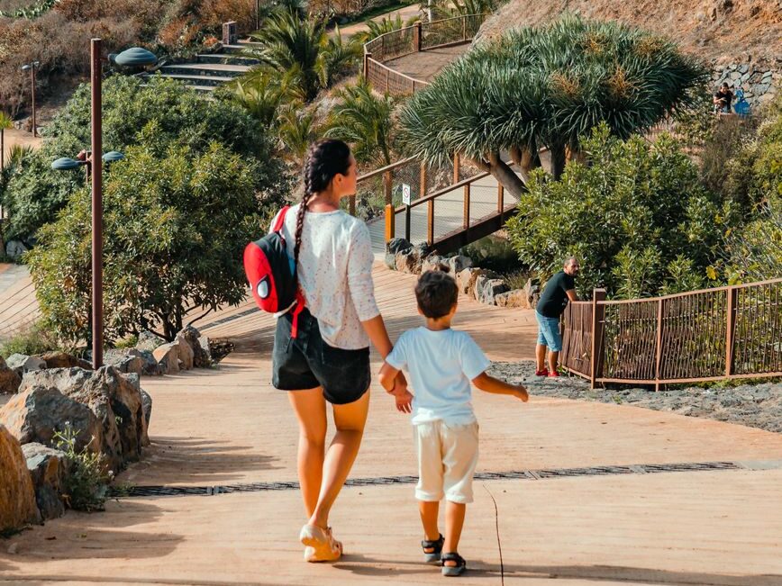 a person and a kid walking on elevated road