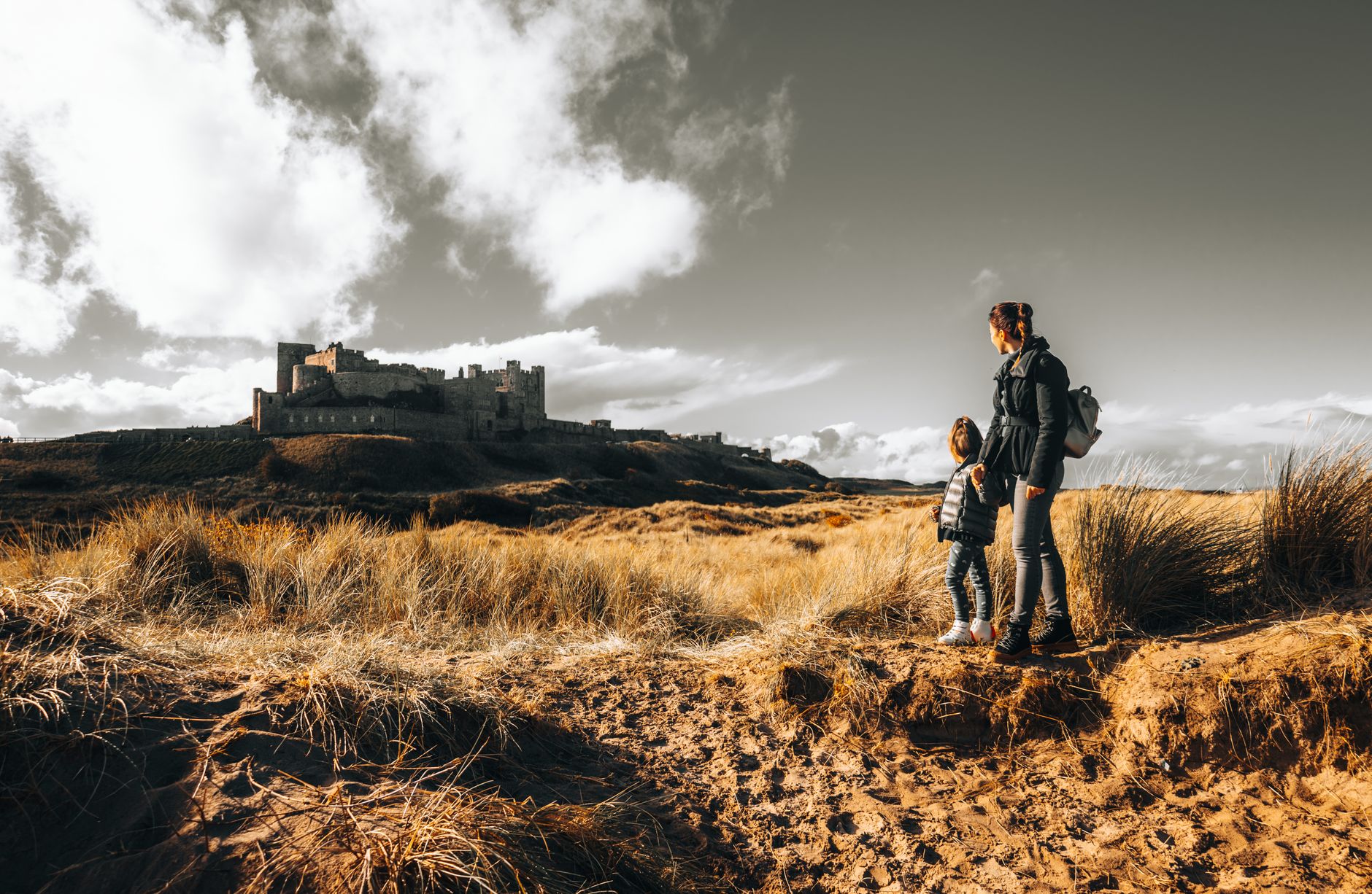 a woman and her daughter looking at a castle